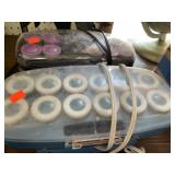 2 sets of hot curlers.