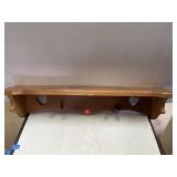 Wood shelf w/ pegs for hanging. 28x5.5x 6high