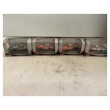 Four 1:87 NASCAR cars in Plastic Display Cases