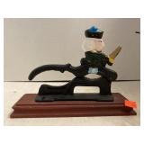 Decorative Cast Iron Nutcracker on Wooden Stand.