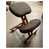 Back relief chair / stool (?). On wheels.