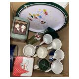 Lot of mugs. Some Christmas tins. Christmas coke