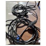 2 black indoor extension cords.  One has multiple