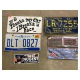 3 license plates. 2 metal signs. 1 sticker.