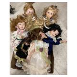 7 Porcelain dolls. Composite (cloth) body.  Most