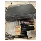 Box of VHS, VHS Player, Empty Cases, and Midc