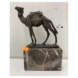 Metal camel on stone base