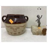 Bean pot and pewter boy figure on stone