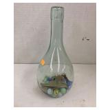 Wine bottle filled with bay leaves and marbles