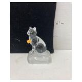 Glass cat on pillow