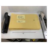 Manila envelopes, hole punch, long armed stapler