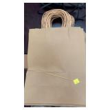 Stack of 24 brown paper gift bags