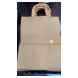 A stack of 24 brown paper gift bags