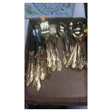 Gold tone flatware set.  Stainless steel