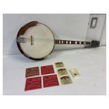 Raven Banjo with extra stings and picks