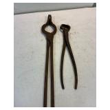 Blacksmith tongs and hoof trimmers.