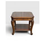 Angled corner ornate leg accent table