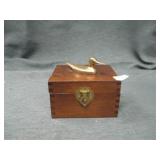 small wooden box with brass duck.