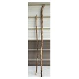 Two Wooden Walking Sticks of Varying Sizes