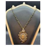 Beautiful vintage brass-tone decorative pendant necklace….pendant is accented with center locket and clear stones….top of pendant is a vintage spoon (see pics)