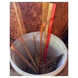 Trash can contents - pruners, trimmers, hand saws, straps, yardsticks and an axe