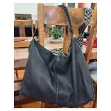 Authentic BOTTEGA VENETA soft black leather handbag…..Seriel number B04358681E….there are ink pen stains on inside bottom lining