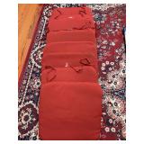 Set of (8) red lightly padded chair cushions with ties…..19”