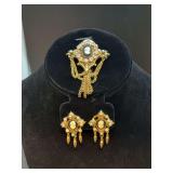 Beautiful vintage Coro Victorian Revival-style matching cameo brooch and clip-on earring set enhanced with beading and clear stones