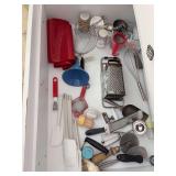 Contents of middle kitchen drawer…..utensils, measuring cups/spoons, spatulas and much more