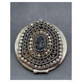 Vintage silver-plated Art Nouveau-style compact enhanced with cameo center surrounded by clear stones (some are missing)