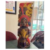 Vintage hand-carved and painted wooden Mayan Aztec-inspired totem pole statue with natural earthy tones of blue, red, brown, and yellow…..8”w x 25-1/4” tall