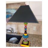 Fun and festive multi-colored wood base lamp with shade (shade has a small damaged spot)