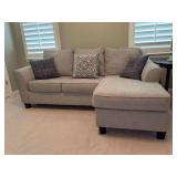 Ashley Furniture Kestrel Sofa Chaise in a light gray fabric - includes 3 throw pillows….in good condition