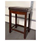 Solid wood base stool with brown faux leather saddle seating…..17 x 12 x 26-1/2 tall