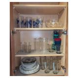 Contents of kitchen cabinet - glassware, plastic cups, 9 miscellaneous pieces of Damon Wood Stoneware…..MUST TAKE ALL AND SANTA PLATES ARE NOT INCLUDED