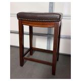 Solid wood base stool with brown faux leather saddle seating…..17 x 12 x 26-1/2 tall