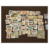 Collection of stamps, a natural diamond, two(2) arrowheads, and a coin sleeve depicting the 1969 Neil Armstrong Moon Walk(NO COIN)...