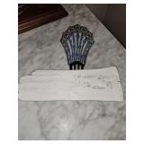 Vintage leather gloves with an antique Art Deco fan-shaped hair comb used as a display stand. Very unique.