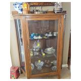 Lighted oak 'triangular' curio cabinet. 44x17x57 in tall. Contents NOT included.