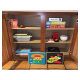 Kitchen cabinet of games, puzzles, UNO cards and shuffler and more
