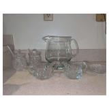 Grouping of nice looking clear glass - (2) crystal lidded jam jars with spoons, etched creamer/sugar bowl set with spoon, 6 glass coasters and 1 large pitcher with ice lip (has chips around rim)