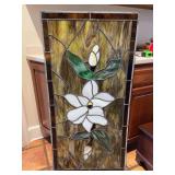 Stained glass panel depicting magnolia blooms design…..23-3/4 x 47-3/4…..one crack on left middle possibly from slight bow/bend