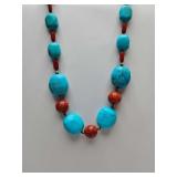Southwestern style statement necklace featuring large turquoise and red coral beads. 925 silver adjustable clasp.
