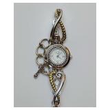 The Brighton Charleston watch is a two-tone wristwatch featuring a jewelry-inspired design with mixed metal links and a round face. With gift can. Not working.