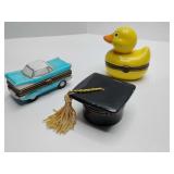 Hinged porcelain trinket boxes from the Midwest of Cannon Falls PHB Collection, including a graduation cap with a tassel, a yellow rubber ducky, and a light blue vintage car.