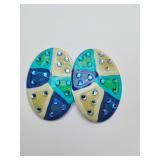 Pair oval stud earrings in a Geometric, pinwheel-like pattern in a palette of blues, greens, and tan. Small, sparkling blue rhinestones are embedded within each color segment to add texture and light.