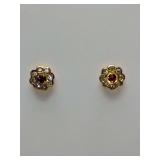 Flower stud earrings, red center stone, surrounded by clear stones in gold setting. Backs have 14K stamped on them, weigh 2 grams.