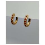 Vintage gold-tone huggie hoops from Avon featuring red rhinestones. Need backs