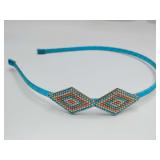 Beaded headband with a geometric, Southwestern-inspired diamond pattern. It is handcrafted using small seed beads.