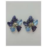 Whimsical floral-shaped studs featuring blue and purple gradient colors with glitter details, silver pistols.